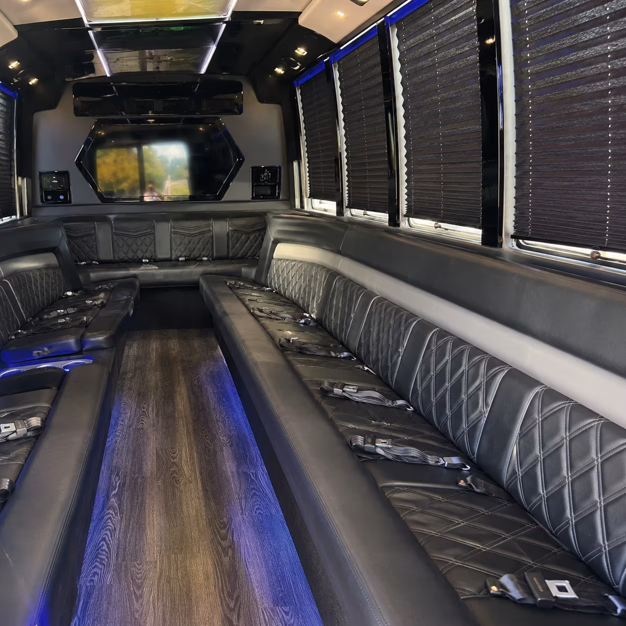 Friends laughing during a party bus celebration in San Antonio